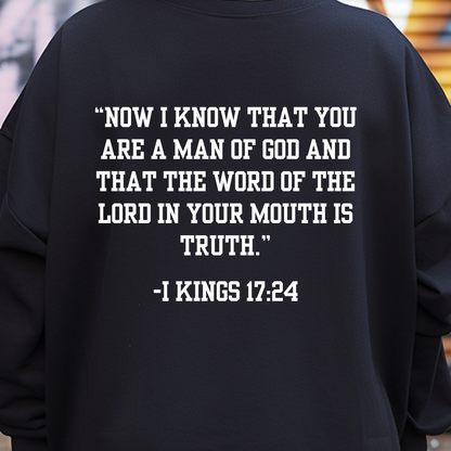 Contemporary black sweatshirt for Men, featuring 'Man of God' art on the front and I Kings 17:24 scripture on the back. Embrace style and faith with this unique design.