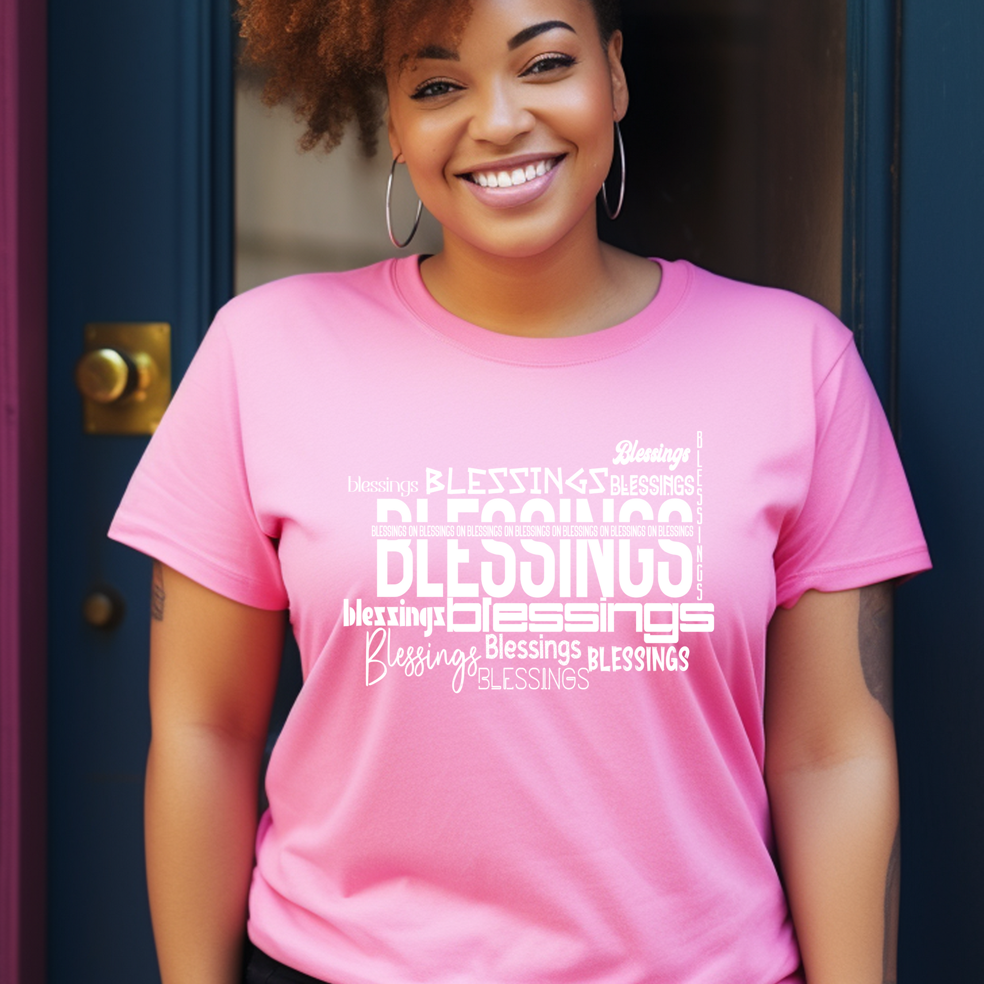 Chic pink 'Blessings on Blessings' T-shirt from Triumph Tees. This faith-themed apparel combines style and comfort, perfect for those wanting to express their faith in a fashionable way.