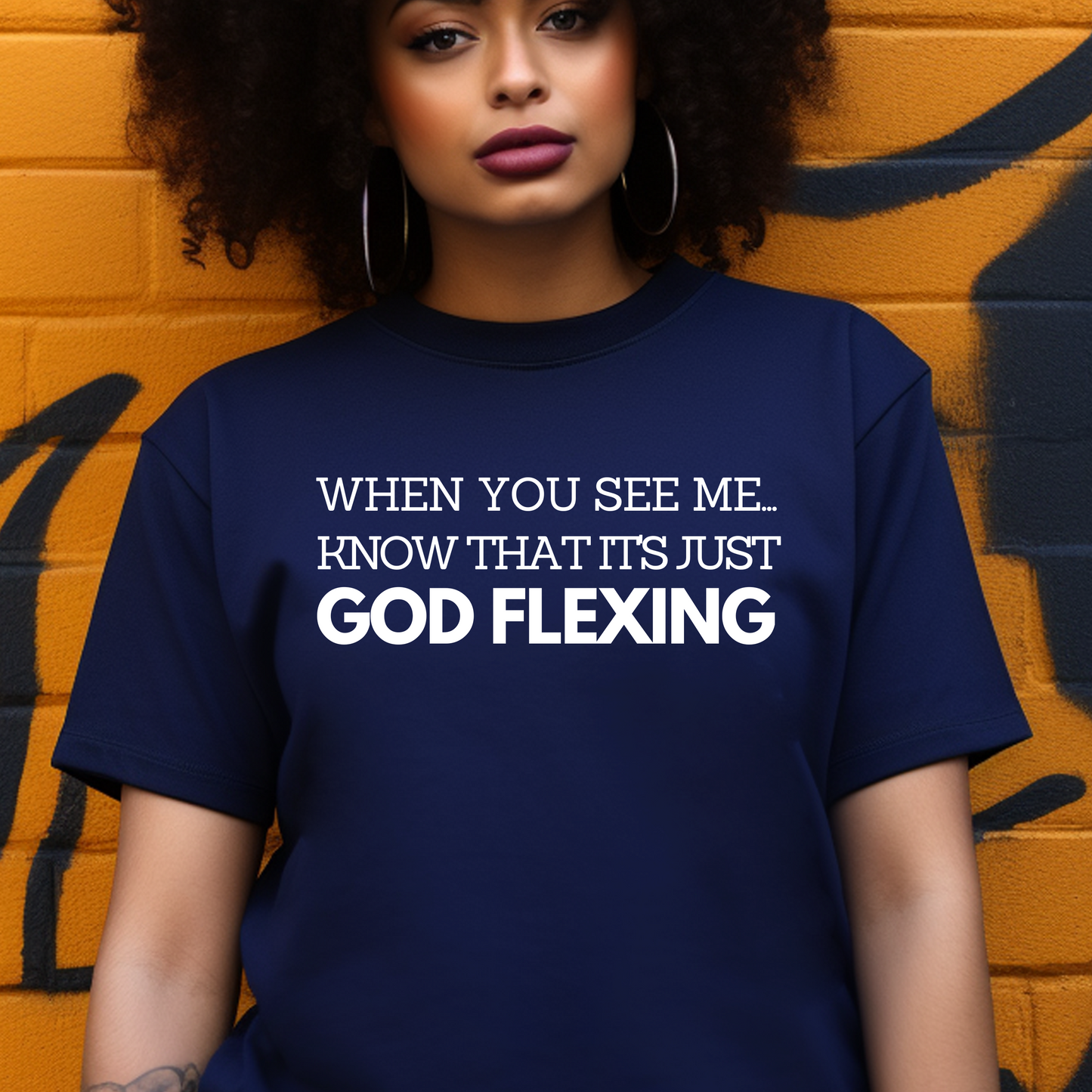 Elegant navy 'When You See Me Know That it's just God Flexing' T-shirt from Triumph Tees. This faith-themed apparel is a fashionable way to display your belief and devotion to God.