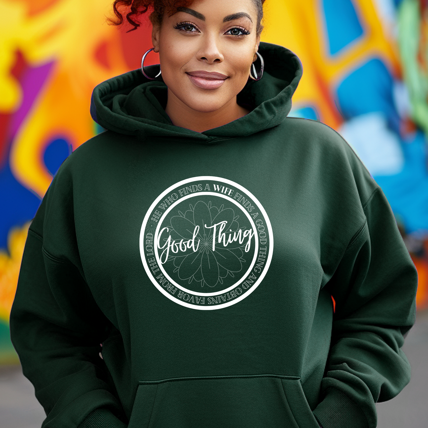 Trendy green 'Good Thing' hoodie from Triumph Tees, echoing Proverbs 18:22. This faith-based apparel is a fashionable way to display your belief and acknowledge God's favor.
