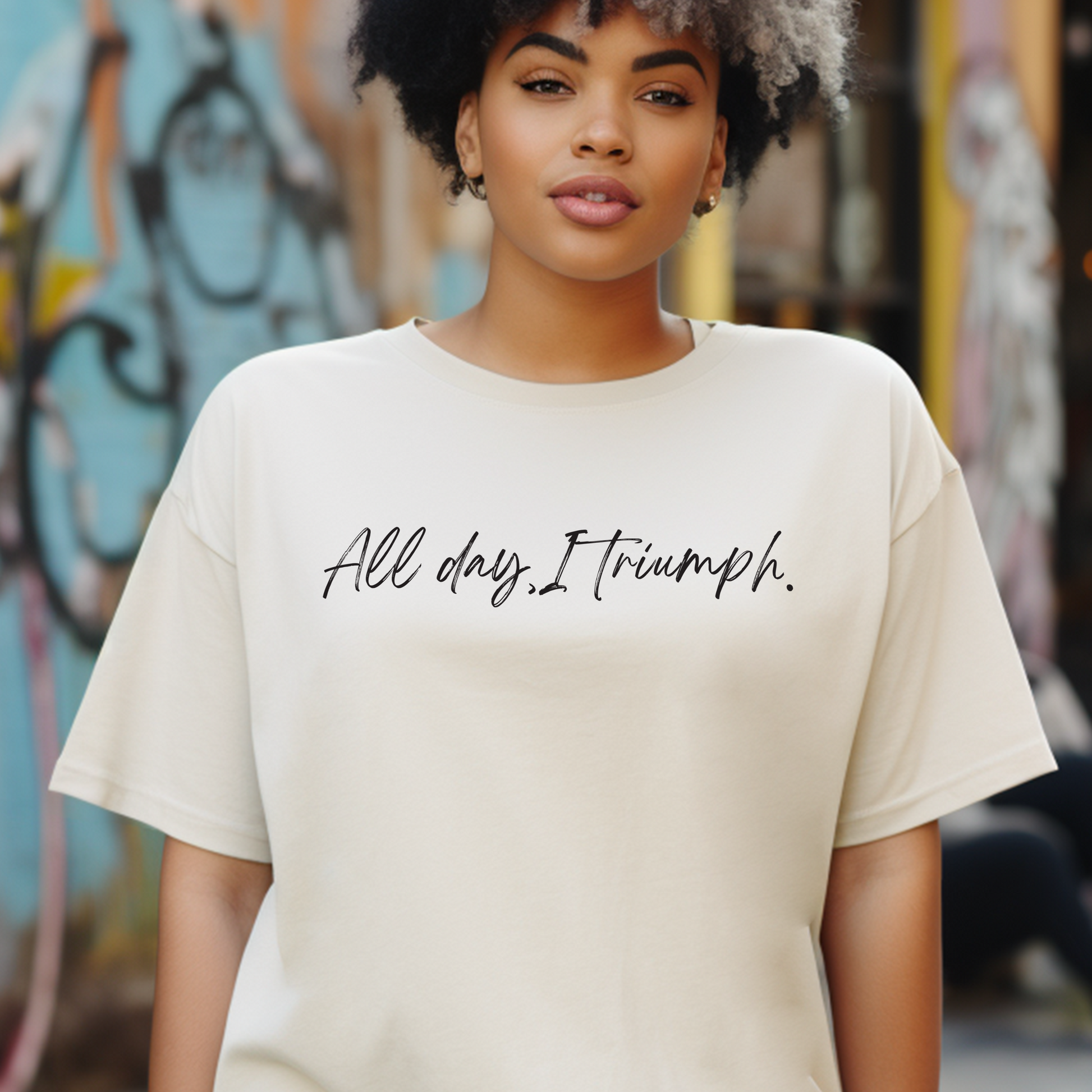 Elegant natural cream 'All Day I Triumph' t-shirt from Triumph Tees, designed to instill courage and faith. This faith apparel serves as a reminder of the God-given strength to triumph over life's obstacles.