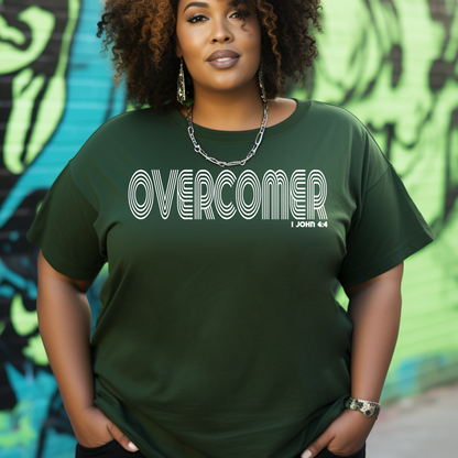 Stylish forest green Overcomer t-shirt featured at Triumph Tees, inspired by 1 John 4:4, underscoring our triumph as overcomers through God. This faith-inspired apparel is a rich symbol of spiritual victory.