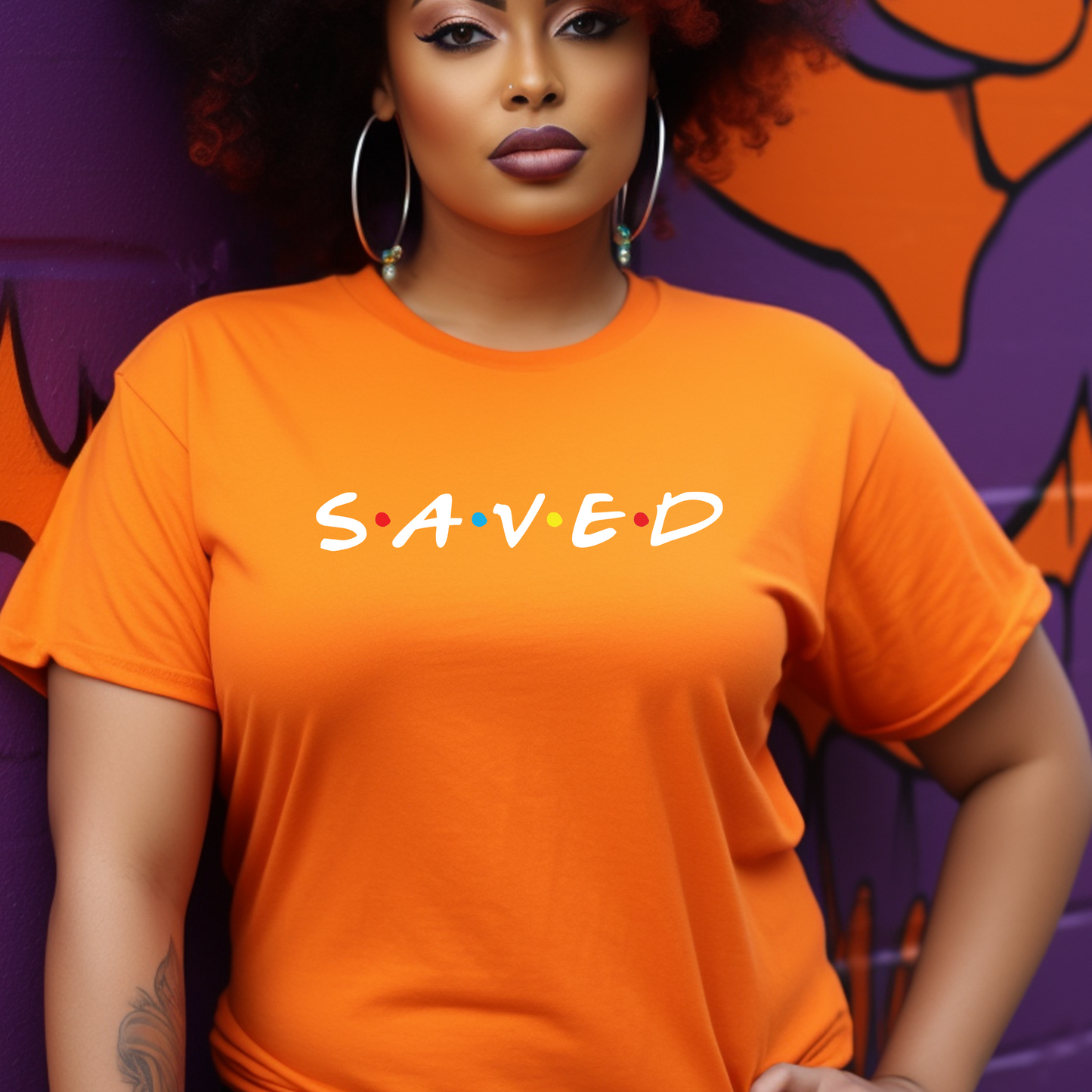 Eye-catching orange 'Saved' t-shirt at Triumph Tees, symbolizing salvation in faith. This God-themed apparel is a trendy way to express religious beliefs.